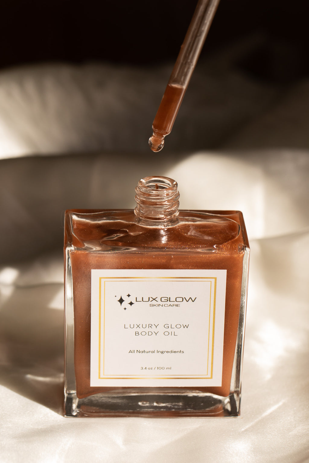 FEATURES

Premium blend of natural botanical oils and butters

Lightweight, fast-absorbing luxe body oil

Fine, light-catching shimmer for a radiant bronze glow

Warm vanilla aroma for a sensual, soft fragrance

Enriched with Vitamins A, D & E for enhanced skin nourishment

Handcrafted in small batches in the USA

BENEFITS

Leaves skin illuminated with a smooth, sun-kissed shimmer

Deeply moisturizes and softens dry or dull skin

Enhances natural skin tone with a healthy, warm radiance
